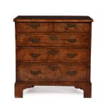 A GEORGE II WALNUT AND FEATHERBANDED CHEST OF DRAWERS, CIRCA 1735