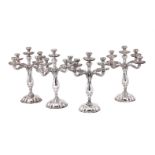 A SET OF FOUR SPANISH SILVER FIVE LIGHT CANDELABRA