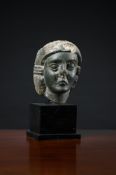 AN EARLY CARVED GREEN BASALT HEAD, POSSIBLY LEVANTINE OR PALMYRENE