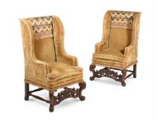 A PAIR OF CARVED WALNUT WING ARMCHAIRS, CIRCA 1700 AND LATER