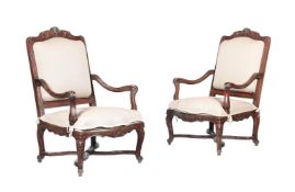 A PAIR OF RÉGENCE CARVED WALNUT FAUTEUILS, CIRCA 1720