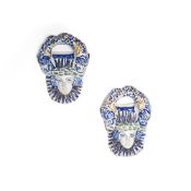 A PAIR OF FRENCH FAIENCE POLYCHROME PAINTED POT HANDLES, MID 17TH CENTURY