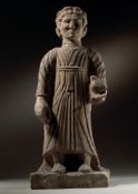A CARVED LIMESTONE STANDING MALE FIGURE, CYPRIOT, 4TH CENTURY B.C.