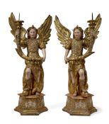 A PAIR OF PAINTED AND GILTWOOD FIGURES OF ANGELS BEARING CORNUCOPIA PRICKETS