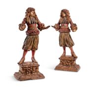 A LARGE PAIR OF CARVED, POLYCHROMED AND GILTWOOD FIGURES OF GENTLEMEN, ITALIAN, CIRCA 1680
