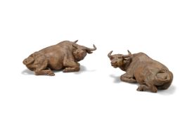 A pair of large Chinese Shiwan brown glazed models of buffalos