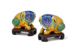 A pair of Chinese glazed models of mythical beasts