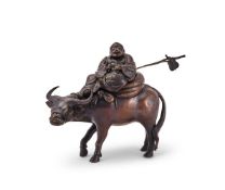 A large Japanese bronze okimono group of Hotei atop a buffalo