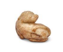 A Chinese mottled jade model of a horned beast