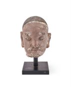 A Chinese carved and painted stone head