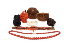 Y A group of assorted coral carvings and netsukes