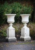 A LARGE PAIR OF WHITE PAINTED IRON CAMPANA VASES AND BASES, 19TH CENTURY