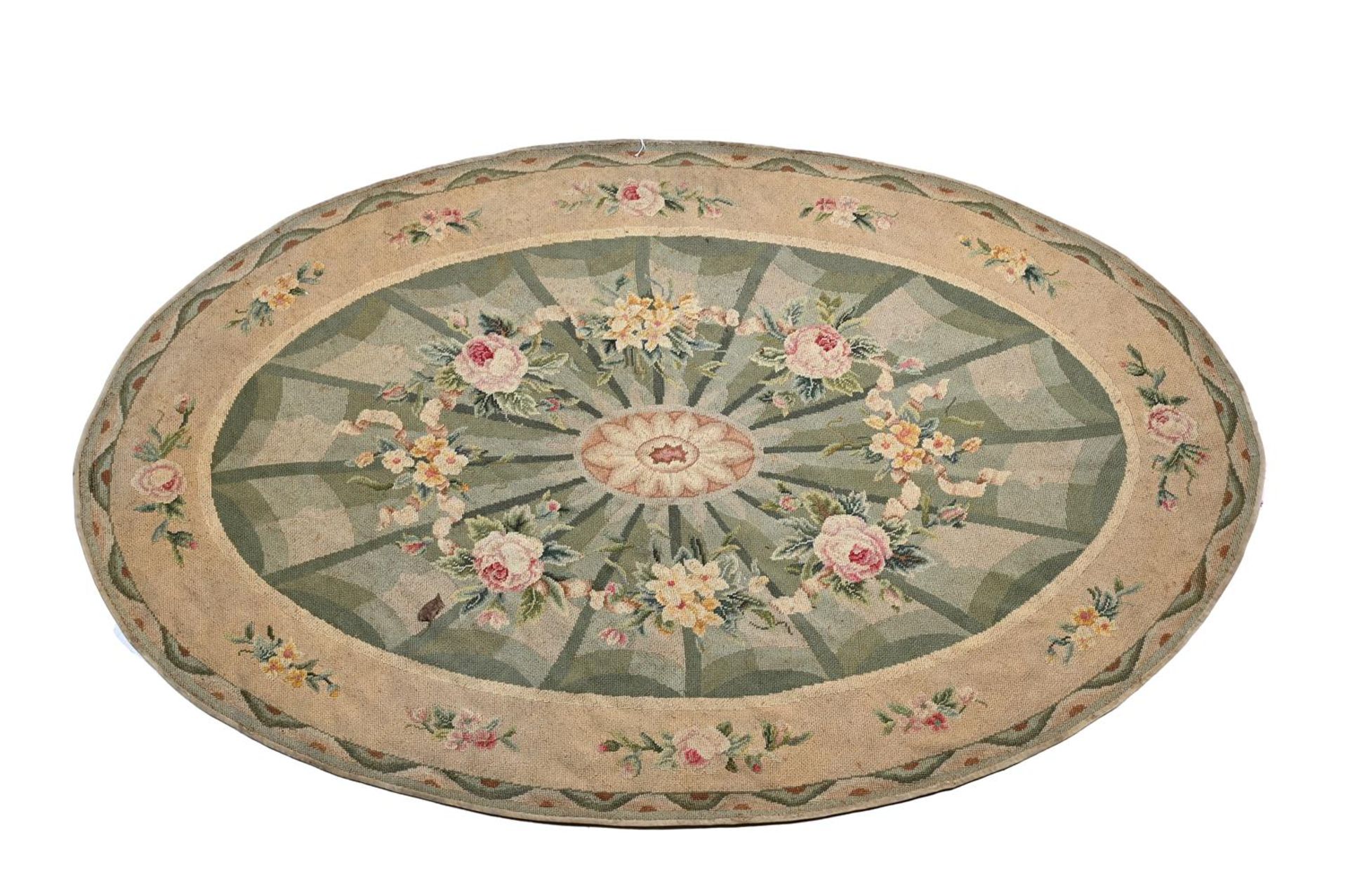 AN OVAL HAND STITCHED NEEDLEPOINT CARPET, IN REGENCY STYLE, MID 20TH CENTURY