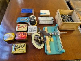 A selection of gramaphone needle tins, needles and needle sharpeners