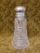 A cut glass silver top sugar shaker