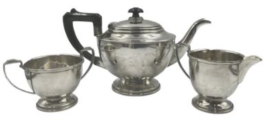 Silver three piece tea set of circular form with a short pedestal foot