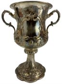 Large Victorian silver two handled cup with embossed floral decoration