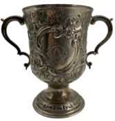 Early George III silver two handled cup with later embossed decoration and monogram