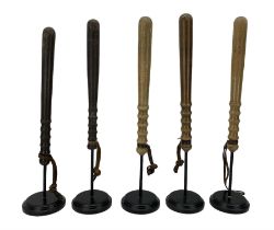 Five turned wooden truncheons with leather wrist straps