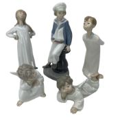 Five Lladro figures comprising Boy with Yacht No.4810