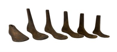 Set of five graduated iron shoe lasts and another