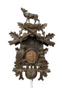 Two German weight driven cuckoo clocks. A large mid 20th century carved case cuckoo clock with a two