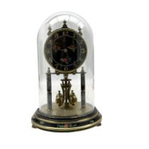 20th century German torsion clock with a four ball rotating pendulum under a glass dome.