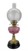 Victorian brass oil lamp with pink mottled glass reservoir