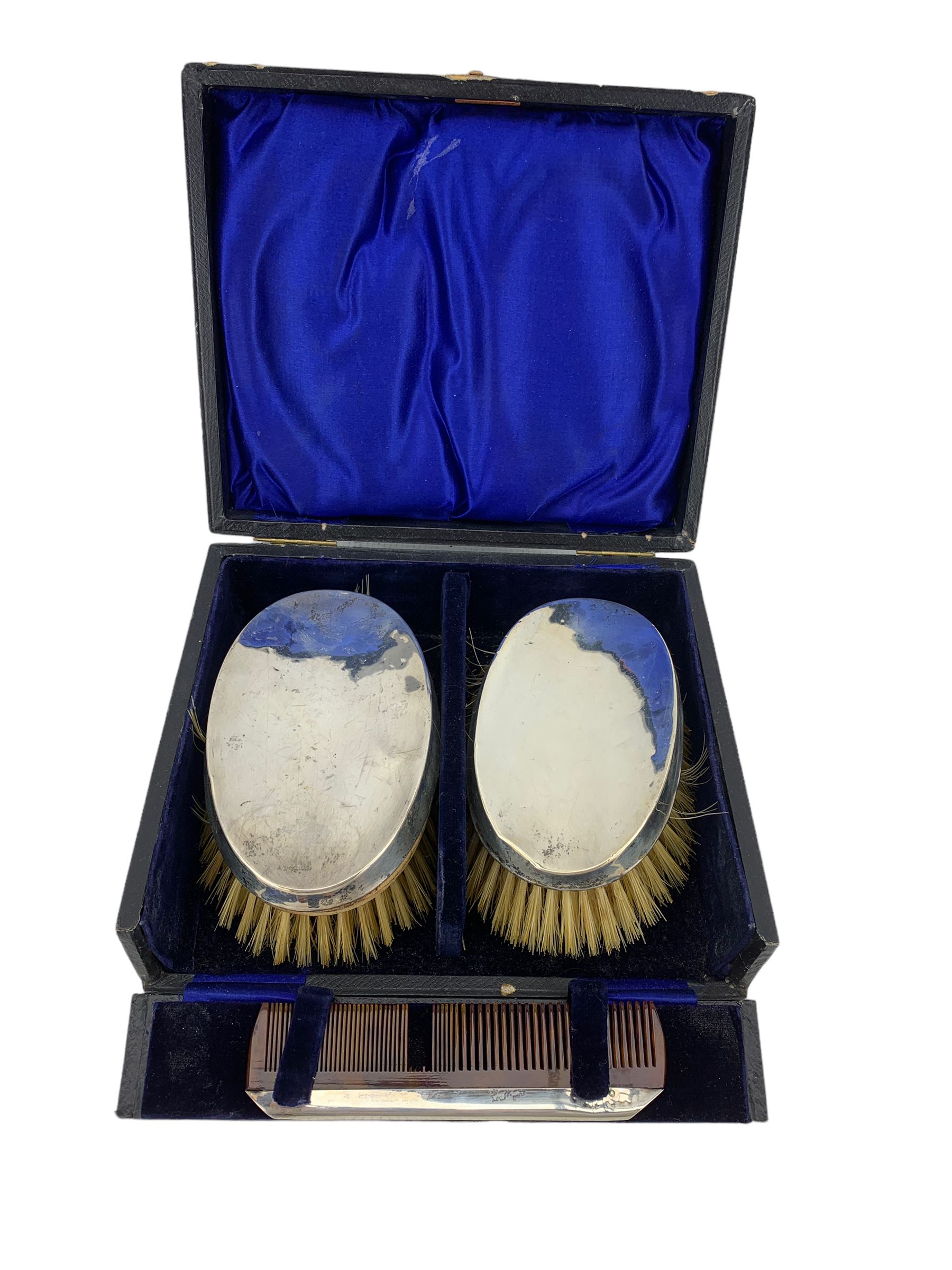 Pair of silver backed brushes and silver mounted comb