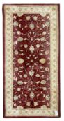 Persian design claret ground rug
