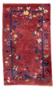 Early 20th century Chinese thick woollen crimson ground rug