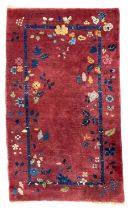 Early 20th century Chinese thick woollen crimson ground rug