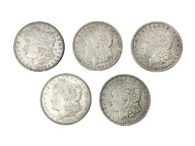 Five United States of America silver Morgan dollar coins