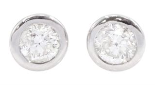 Pair of 18ct white gold bezel set round brilliant cut diamond stud earrings