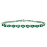 18ct white gold oval cut emerald and round brilliant cut diamond bracelet