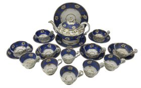 Victorian tea set decorated with flower heads in gilt on a blue border comprising six tea cups