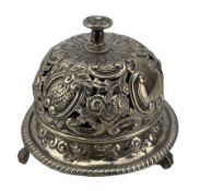 Late Victorian silver table bell of domed circular form with pierced and repousse decoration on paw