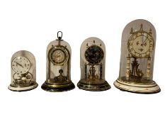 Four assorted 20th century torsion clocks with domes.