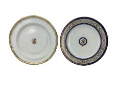 Two Armorial porcelain plates comprising a Davenport plain ground plate centrally painted with the B