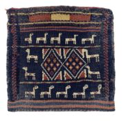 Small Persian flat weave saddle bag with stylised animals and geometric panel on an indigo field wit