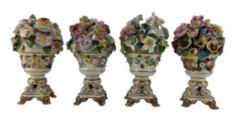 Four early 19th century Derby porcelain urns
