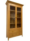Tall light oak display cabinet