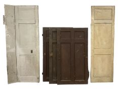 Five various 19th century Country House painted wood panelled doors - three in brown painted finish