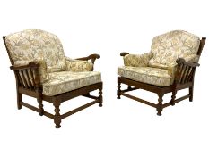 Ercol - pair of 20th century stained elm 'Cloister' wingback armchairs
