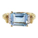 Gold emerald cut blue topaz and diamond ring