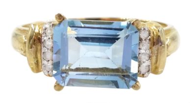 Gold emerald cut blue topaz and diamond ring