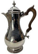 Early George III silver hot water jug of baluster form with gadrooned decoration to the cover and fo