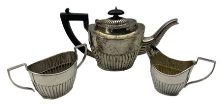 Edwardian bachelors silver three piece tea set with half body decoration