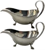 Pair of silver sauce boats with loop handles on triple shaped supports Sheffield 1935 Makers Mark R.