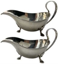 Pair of silver sauce boats with loop handles on triple shaped supports Sheffield 1935 Makers Mark R.